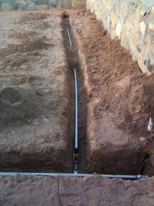 Water lines running along the side and back of yard